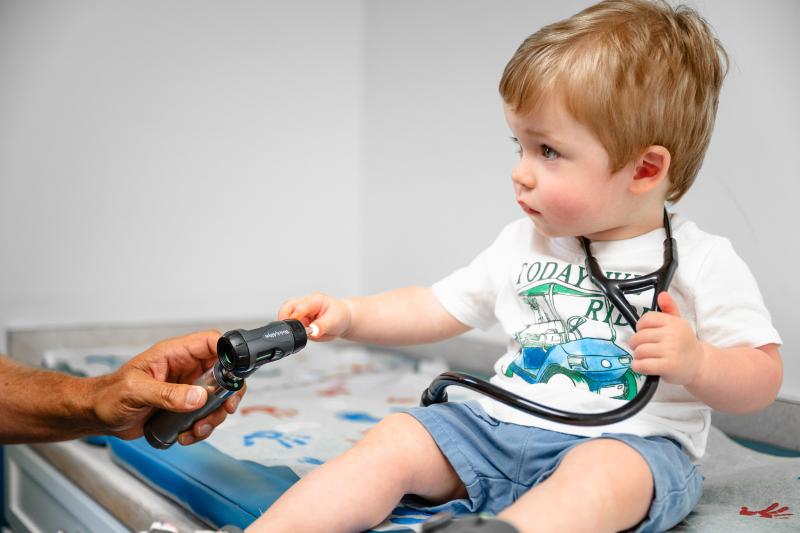 a boy with a stethoscope around his neck